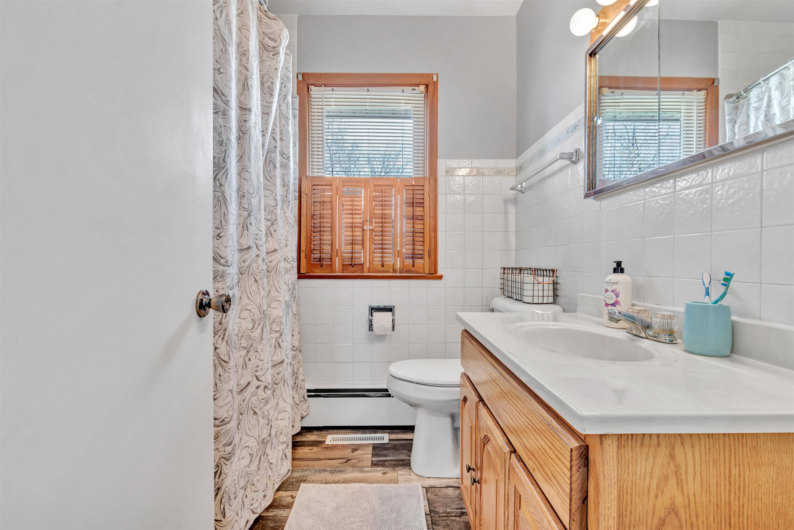 3620 Highcrest Road Rockford, IL 61107 - Photo 10 of 18 a bathroom with a sink a toilet and a window