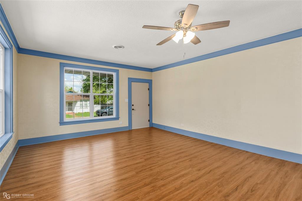 104 3rd Street Northwest Springhill, LA 71075 - Photo 6 of 28 a view of an empty room with wooden floor and a window