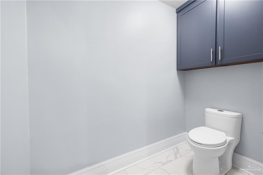 2012 North 46th Street McAllen, TX 78501 - Photo 18 of 41 a white toilet sitting next to a white cabinet