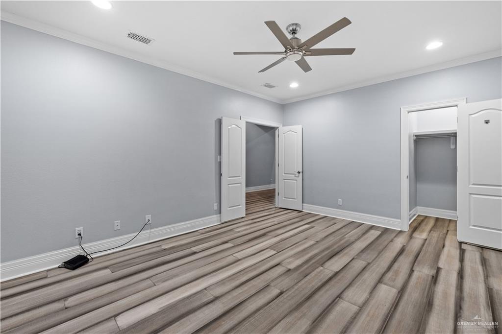 2012 North 46th Street McAllen, TX 78501 - Photo 20 of 41 an empty room with wooden floor and a ceiling fan