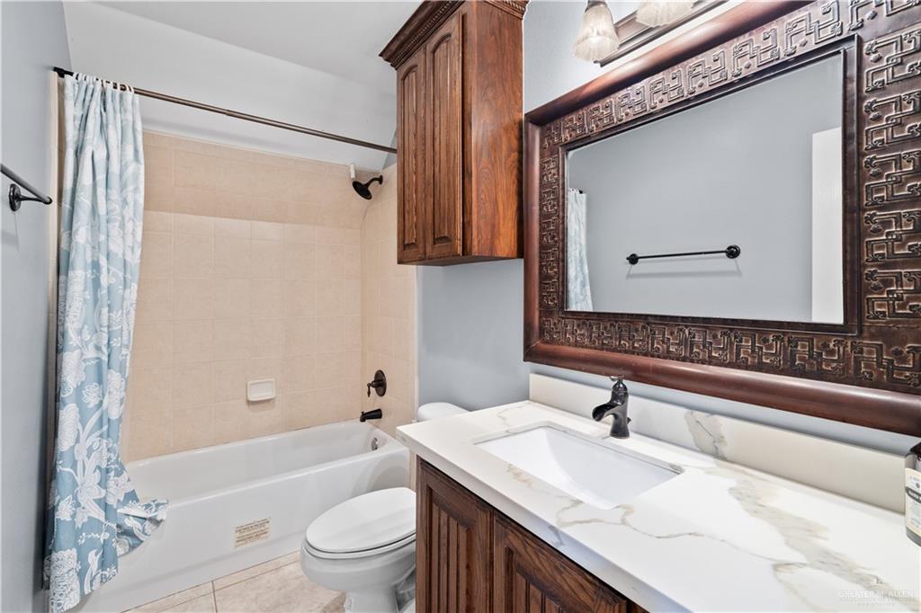 2012 North 46th Street McAllen, TX 78501 - Photo 34 of 41 a bathroom with a granite countertop sink toilet and shower
