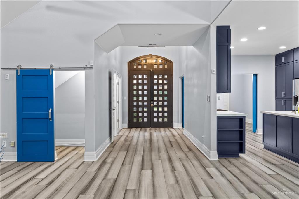 2012 North 46th Street McAllen, TX 78501 - Photo 5 of 41 wooden floor in an empty room with a kitchen