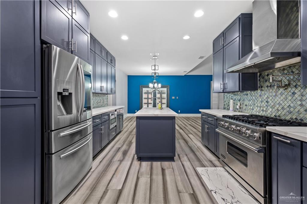 2012 North 46th Street McAllen, TX 78501 - Photo 8 of 41 a kitchen with kitchen island granite countertop a stove oven and sink