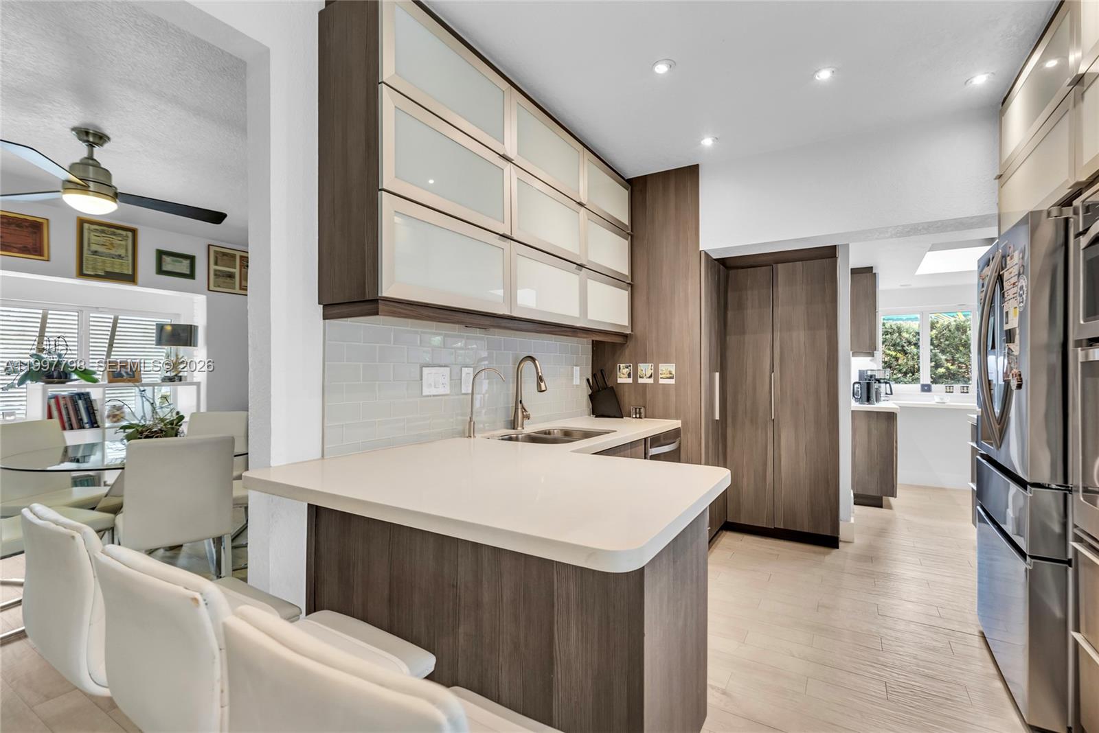 4371 Southwest 13th Terrace Miami, FL 33134 - Photo 12 of 48 a kitchen with a sink a refrigerator and a stove