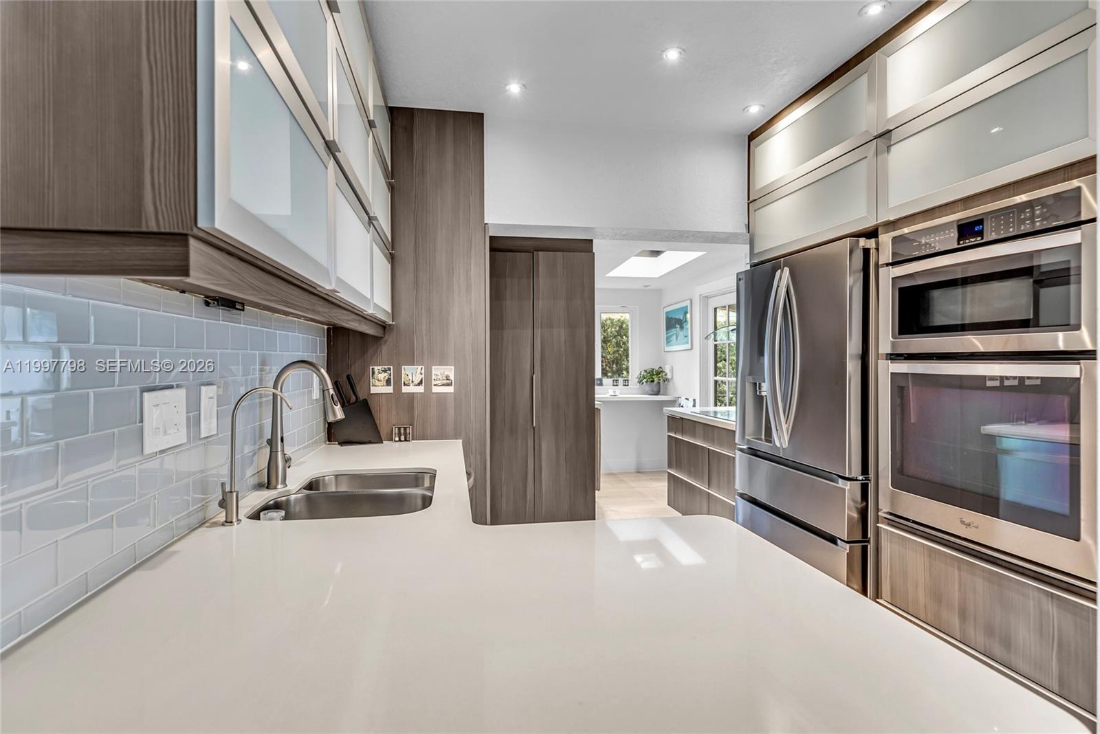 4371 Southwest 13th Terrace Miami, FL 33134 - Photo 13 of 48 a kitchen with stainless steel appliances a refrigerator and a sink