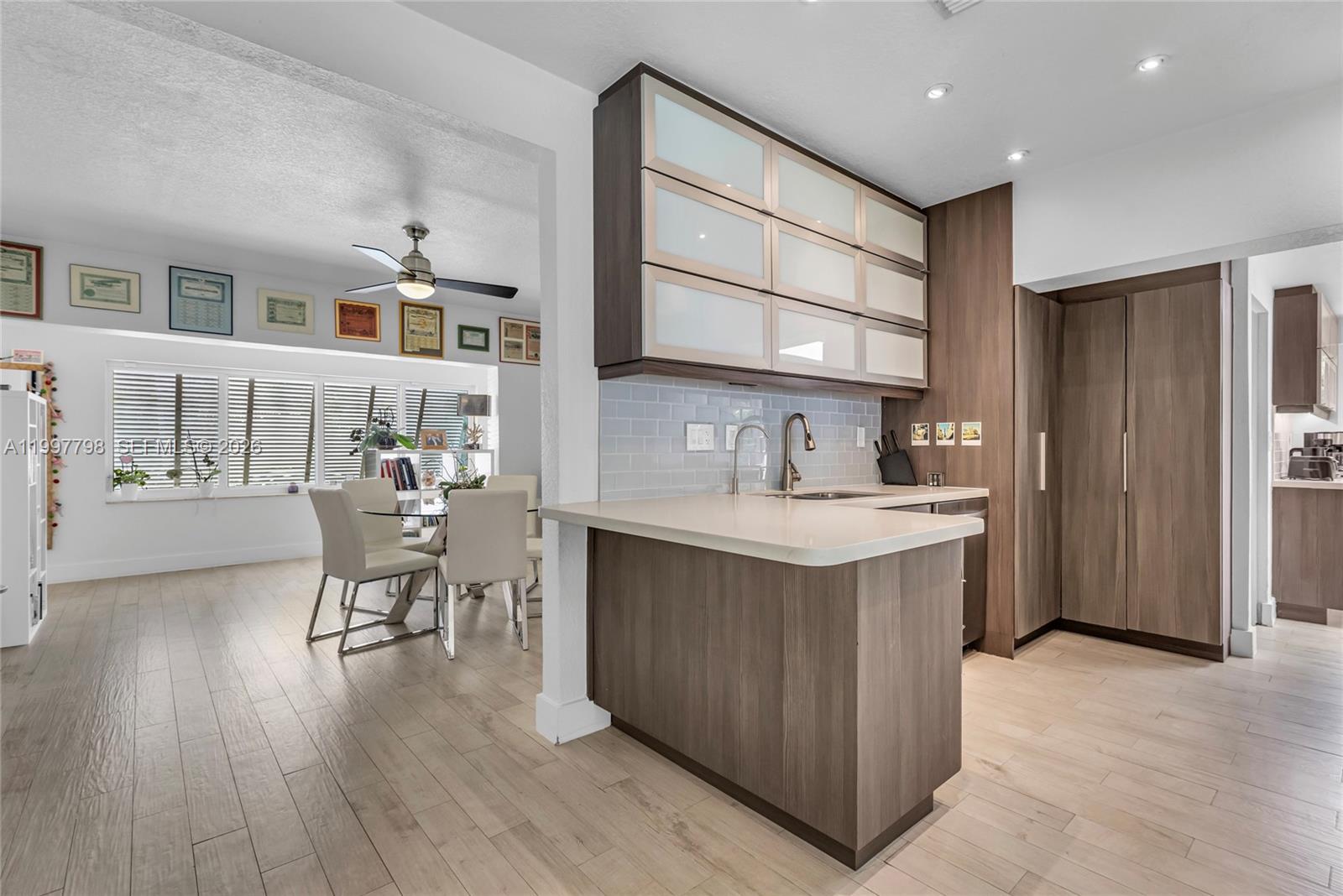 4371 Southwest 13th Terrace Miami, FL 33134 - Photo 18 of 48 a kitchen with furniture and wooden floor