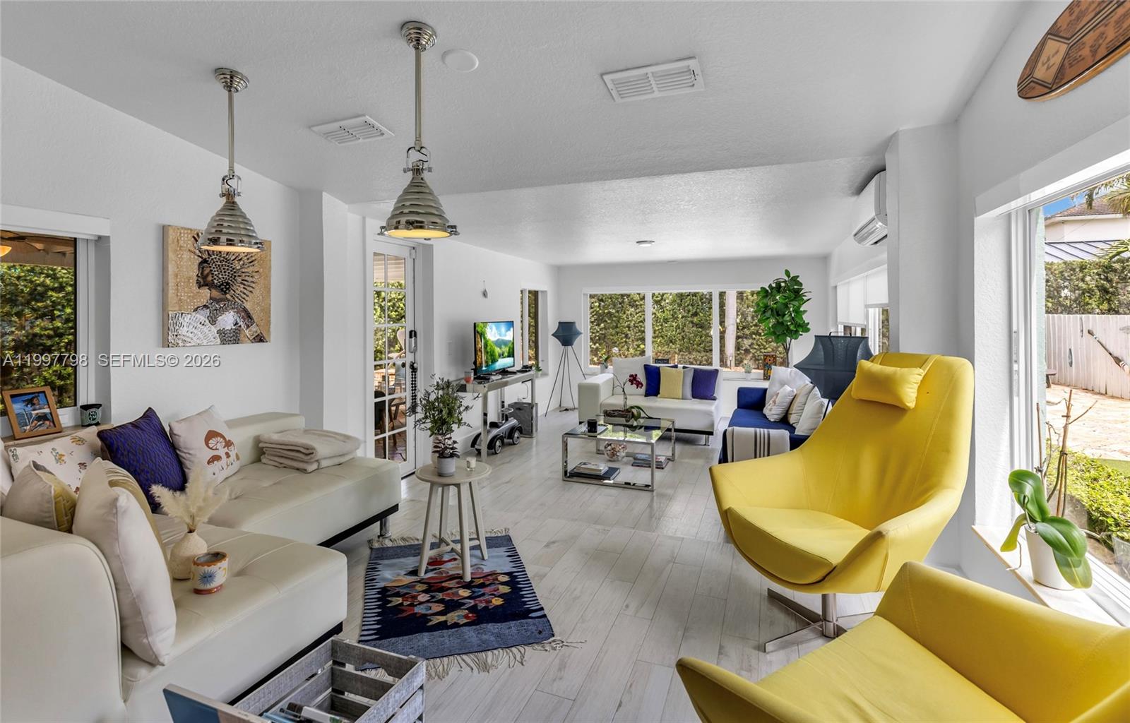 4371 Southwest 13th Terrace Miami, FL 33134 - Photo 20 of 48 a living room with furniture and a chandelier