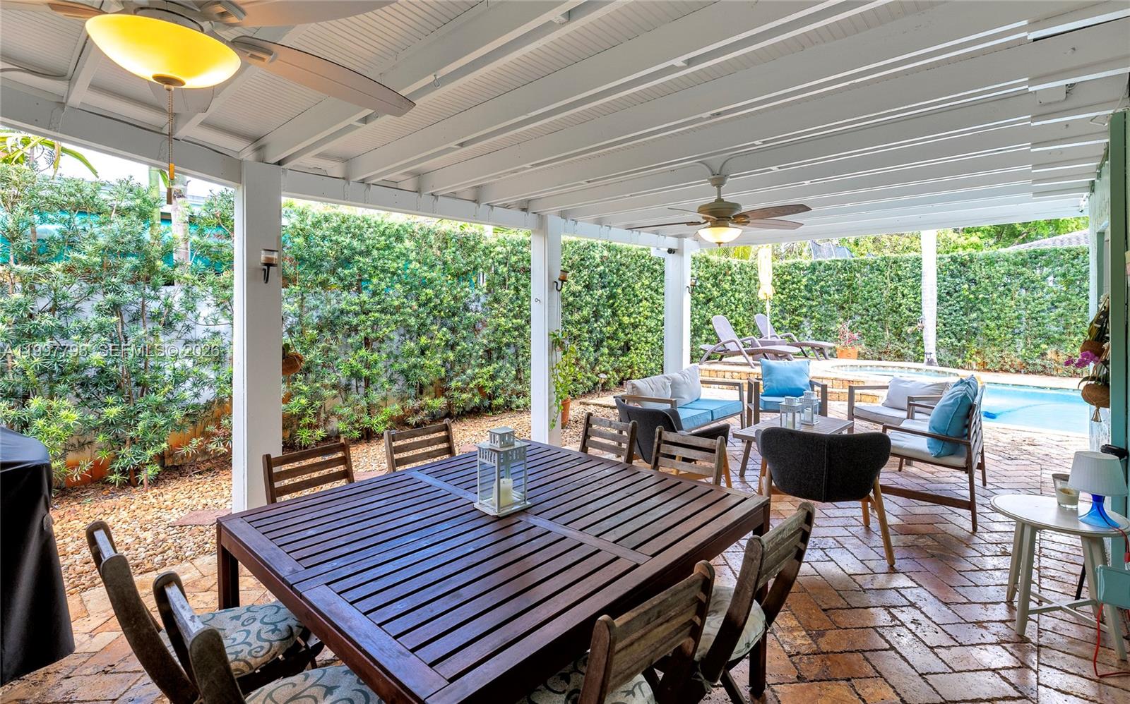 4371 Southwest 13th Terrace Miami, FL 33134 - Photo 2 of 48 a view of a patio with table and chairs and wooden floor