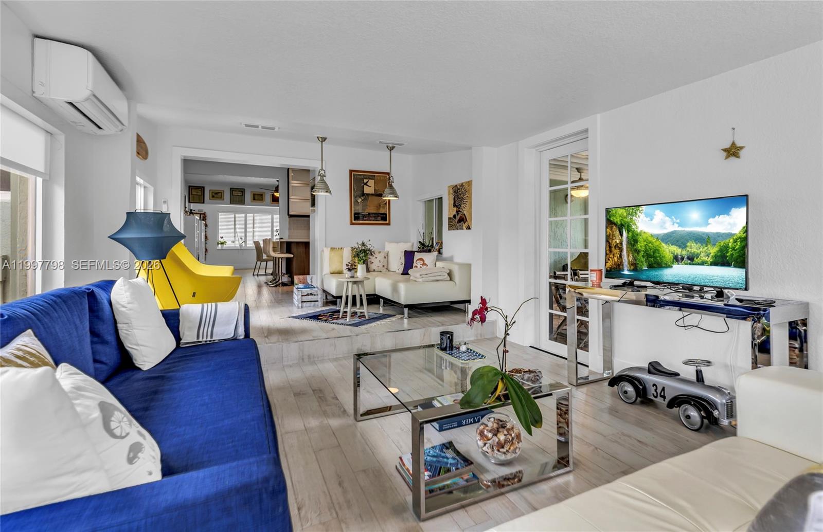 4371 Southwest 13th Terrace Miami, FL 33134 - Photo 21 of 48 a living room with furniture and a flat screen tv