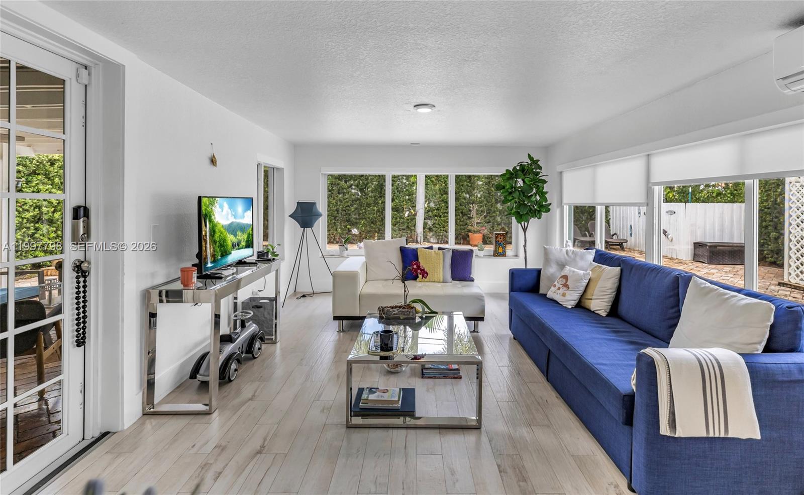 4371 Southwest 13th Terrace Miami, FL 33134 - Photo 24 of 48 a living room with furniture and a flat screen tv