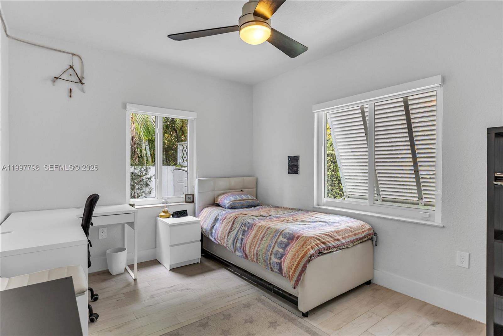 4371 Southwest 13th Terrace Miami, FL 33134 - Photo 26 of 48 a bedroom with a bed and a chandelier