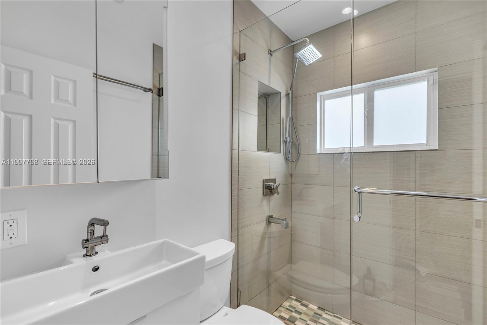 4371 Southwest 13th Terrace Miami, FL 33134 - Photo 27 of 48 a bathroom with a bathtub a sink a window and a shower