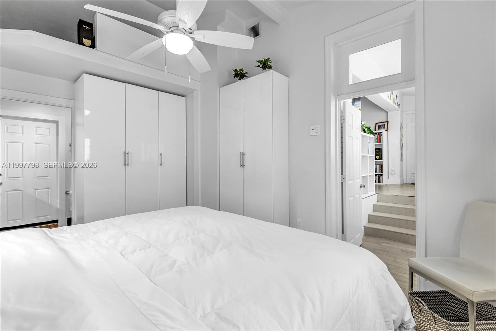 4371 Southwest 13th Terrace Miami, FL 33134 - Photo 29 of 48 a bedroom with a large bed and a chandelier