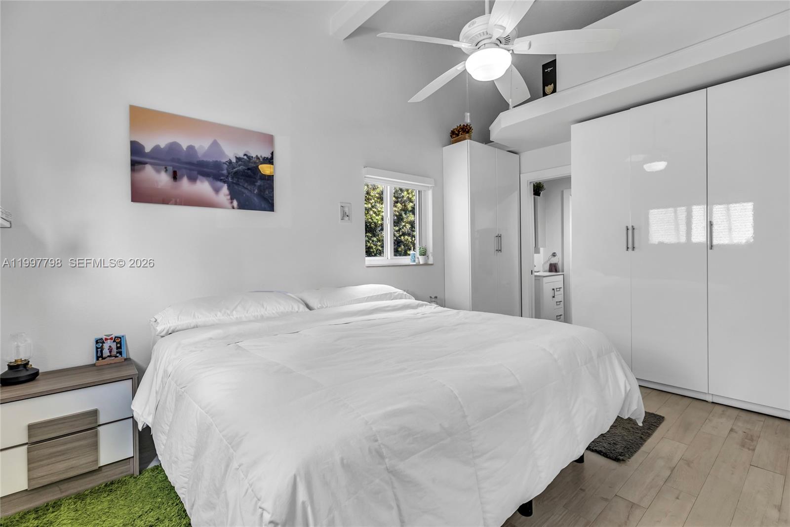 4371 Southwest 13th Terrace Miami, FL 33134 - Photo 30 of 48 a spacious bedroom with a bed and a chandelier