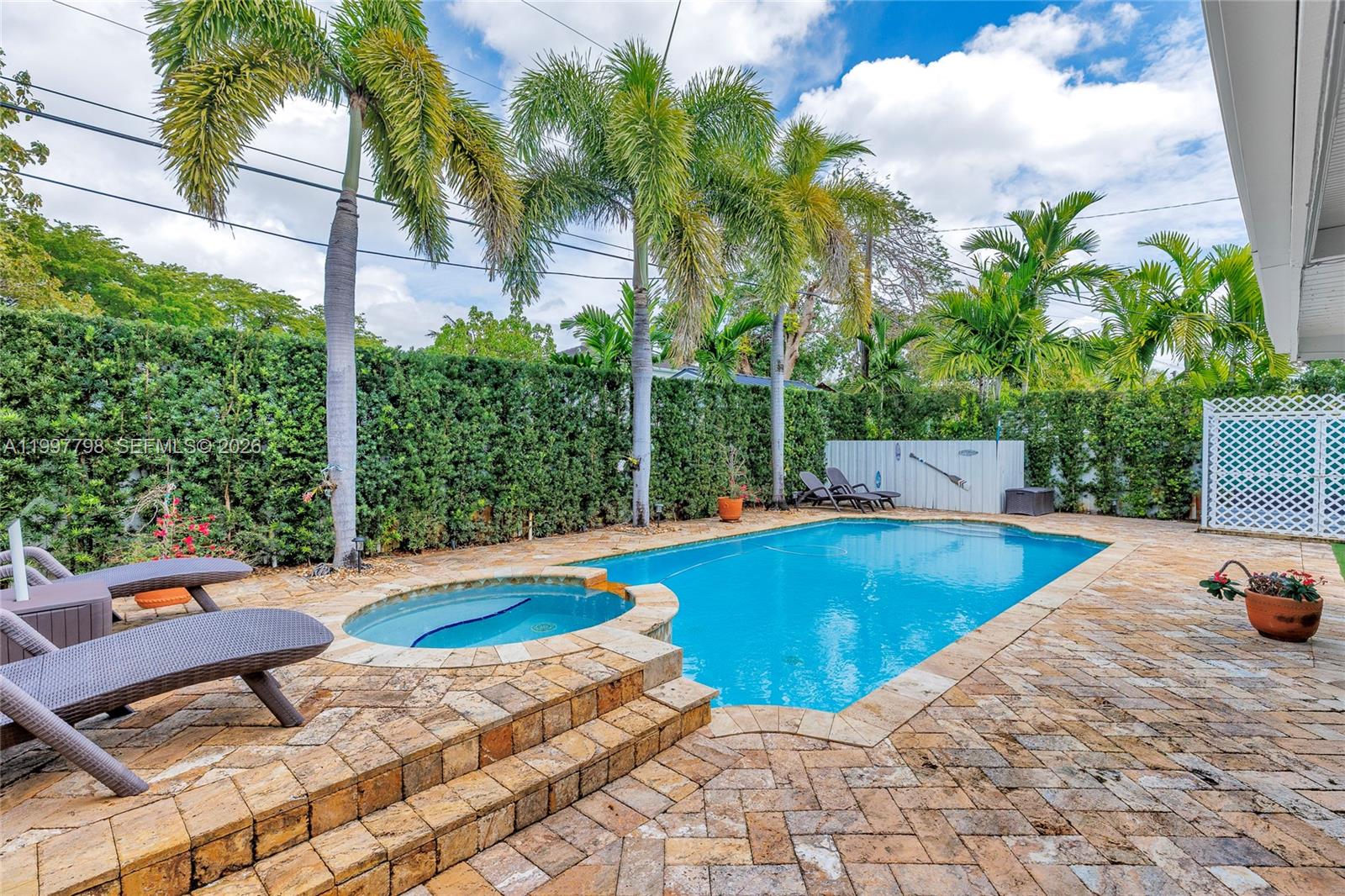 4371 Southwest 13th Terrace Miami, FL 33134 - Photo 3 of 48 a view of a swimming pool with chairs