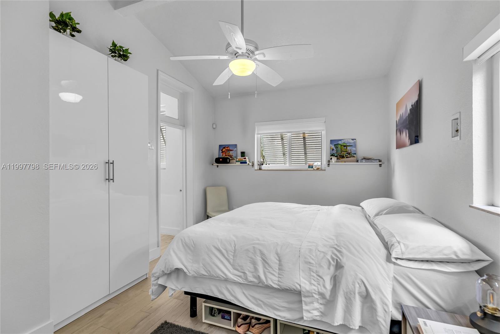 4371 Southwest 13th Terrace Miami, FL 33134 - Photo 31 of 48 a bedroom with a bed and a chandelier