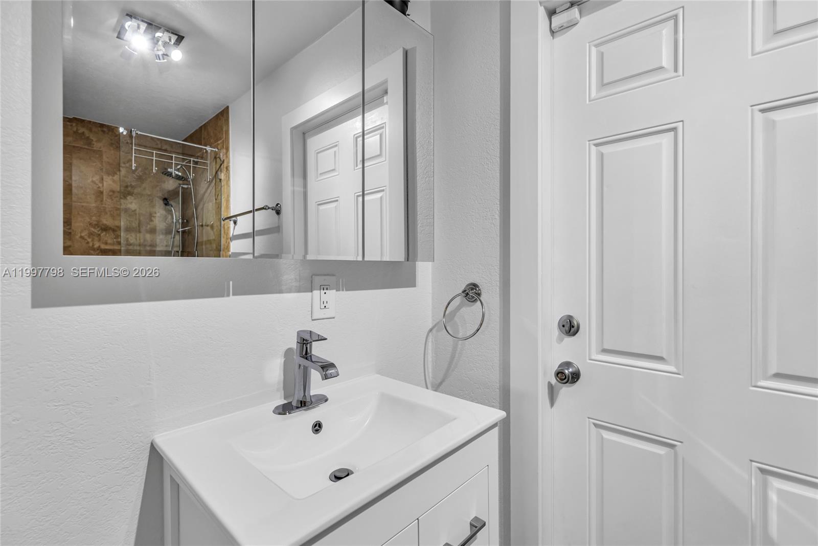 4371 Southwest 13th Terrace Miami, FL 33134 - Photo 32 of 48 a bathroom with a sink mirror and vanity