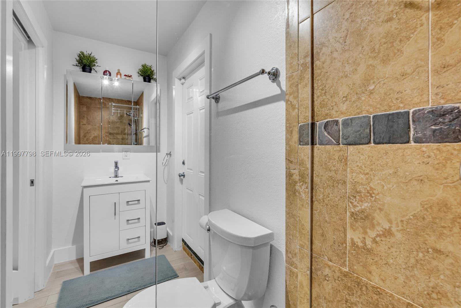 4371 Southwest 13th Terrace Miami, FL 33134 - Photo 33 of 48 a bathroom with a toilet a sink and shower