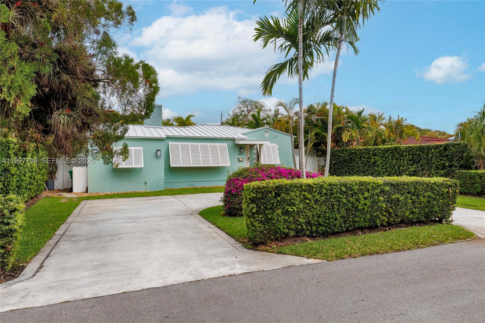 4371 Southwest 13th Terrace Miami, FL 33134 - Photo 34 of 48 a front view of a house with a garden and yard