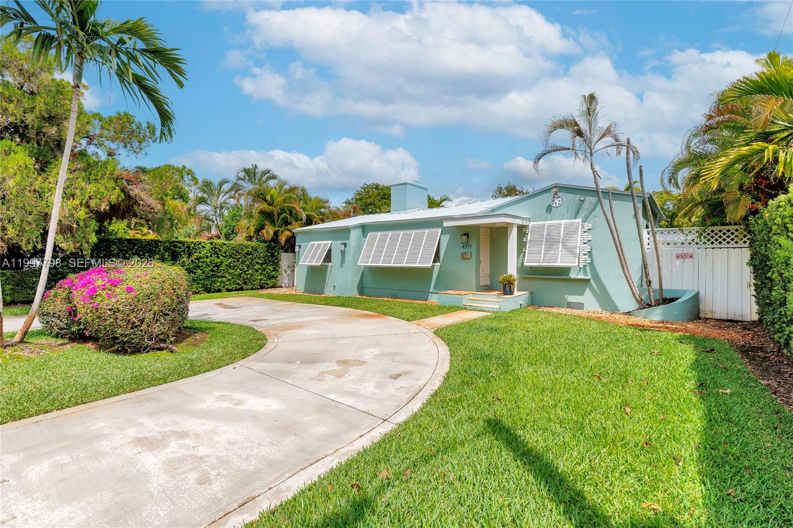 4371 Southwest 13th Terrace Miami, FL 33134 - Photo 36 of 48 a view of a house with a yard and a garden