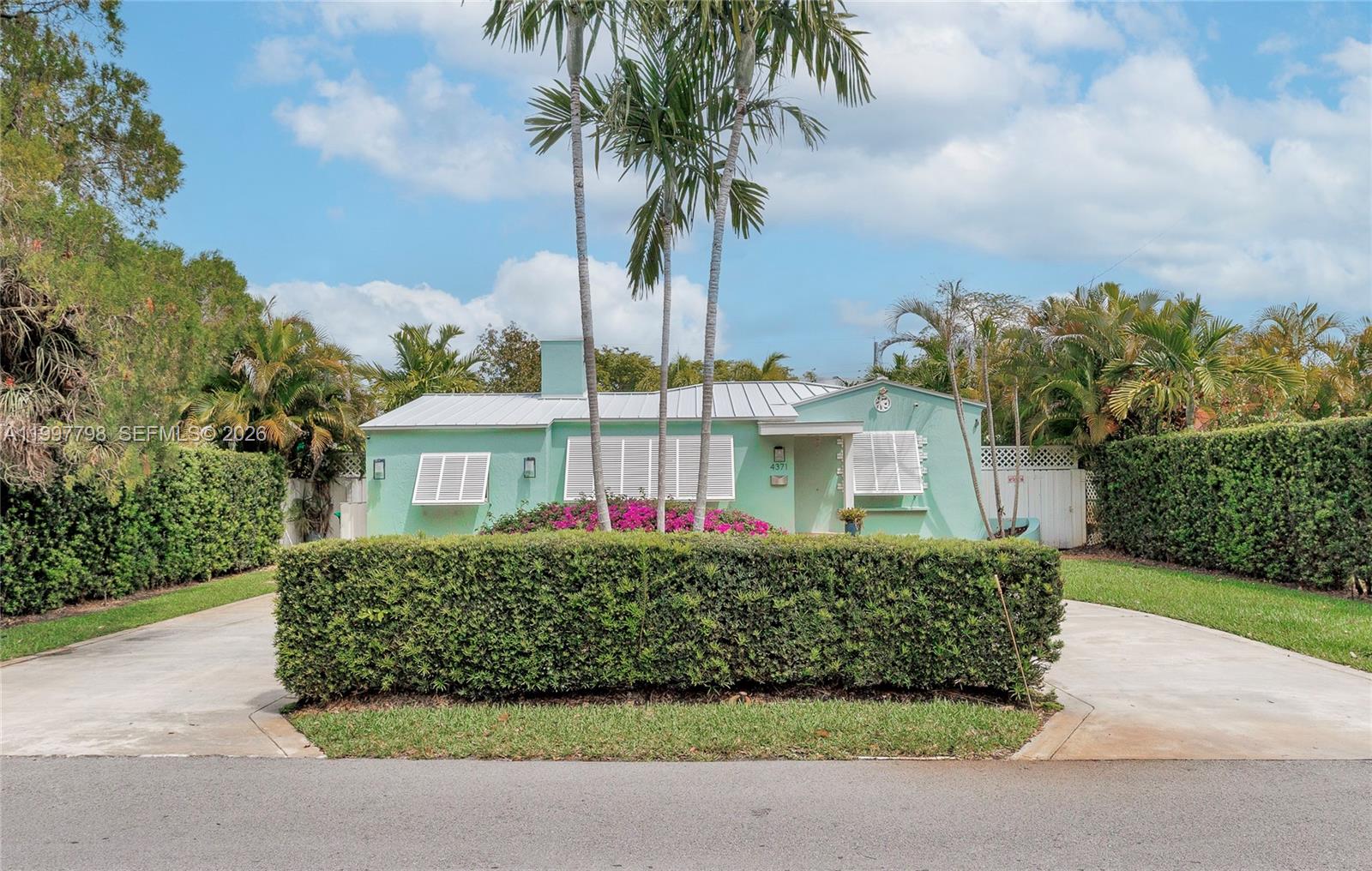 4371 Southwest 13th Terrace Miami, FL 33134 - Photo 38 of 48 a front view of a house with a garden