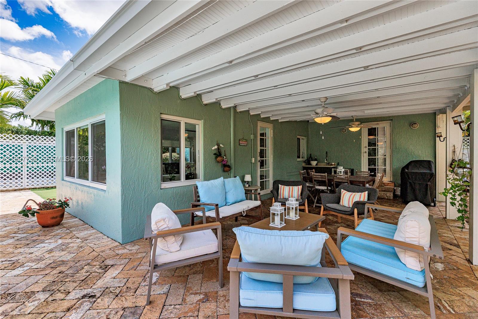 4371 Southwest 13th Terrace Miami, FL 33134 - Photo 4 of 48 a outdoor space with patio the couches and a dining table with chairs
