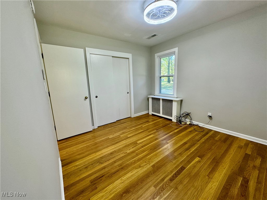 1729 East Pleasant Valley Road Independence, OH 44131 - Photo 24 of 41 Unfurnished bedroom with radiator heating unit and hardwood flooring