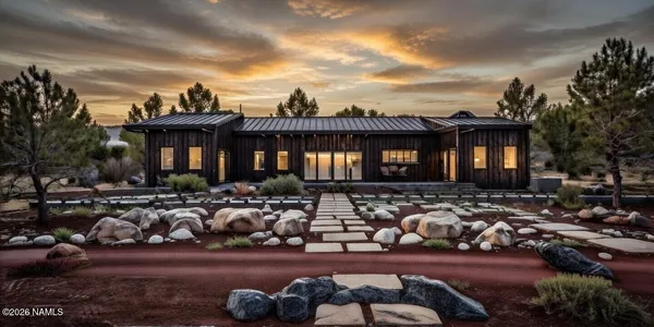 a bedroom with a bed lamp and a large window