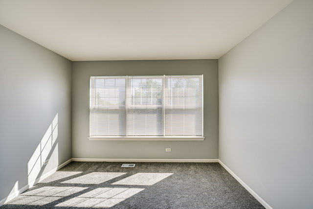3379 Kentshire Circle, Unit 3379 Aurora, IL 60504 - Photo 11 of 17 an empty room with windows