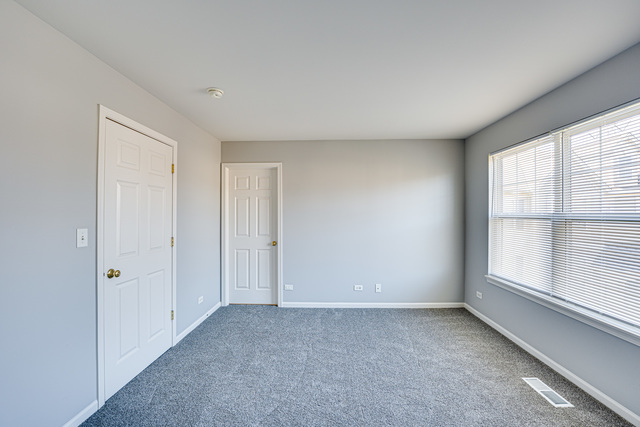 3379 Kentshire Circle, Unit 3379 Aurora, IL 60504 - Photo 14 of 17 a view of an empty room with a window