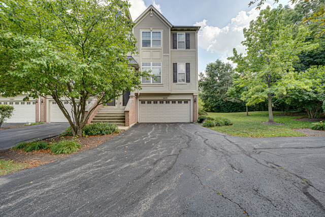 3379 Kentshire Circle, Unit 3379 Aurora, IL 60504 - Photo 2 of 17 a view of a house with a yard and a large tree