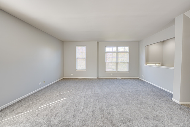 3379 Kentshire Circle, Unit 3379 Aurora, IL 60504 - Photo 4 of 17 a view of an empty room with a window