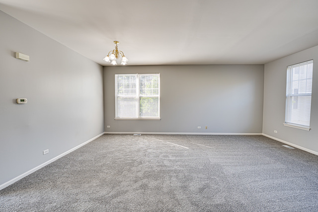 3379 Kentshire Circle, Unit 3379 Aurora, IL 60504 - Photo 5 of 17 an empty room with windows
