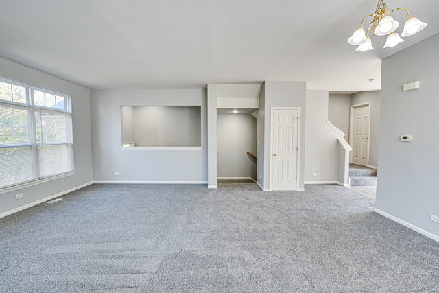 3379 Kentshire Circle, Unit 3379 Aurora, IL 60504 - Photo 6 of 17 a view of an empty room with a window