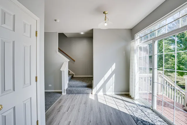 a view of entryway with wooden floor and stairs