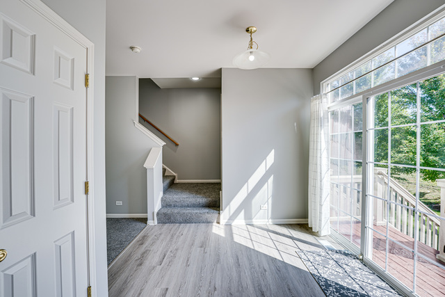3379 Kentshire Circle, Unit 3379 Aurora, IL 60504 - Photo 9 of 17 a view of entryway with wooden floor and stairs