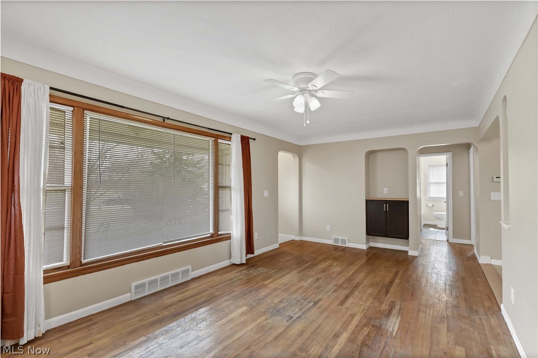 7528 State Road Parma, OH 44129 - Photo 7 of 40 Spare room featuring plenty of natural light, hardwood / wood-style flooring, and ceiling fan