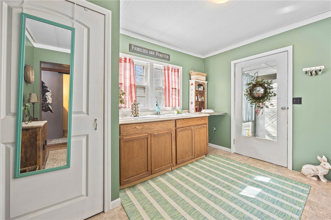 998 Pinewood Road Phelps, NY 14532 - Photo 7 of 39 Mudroom/sunroom flows into a laundry room with fol