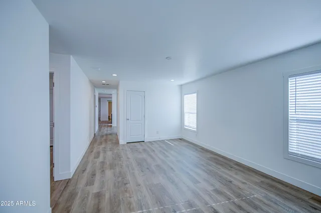 a view of a room with wooden floor and window