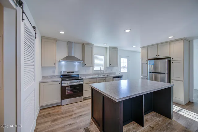 a kitchen with a stove a sink and a refrigerator