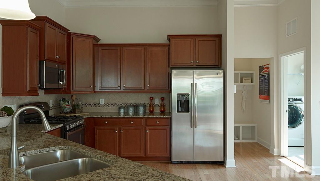 7430 Randshire Way Raleigh, NC 27616 - Photo 8 of 25 a kitchen with stainless steel appliances granite countertop a refrigerator and a sink