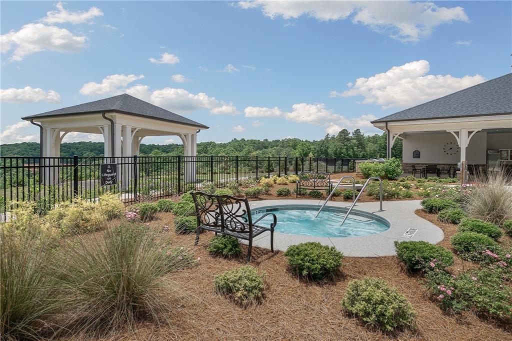 2426 Naples Street Hoschton, GA 30548 - Photo 7 of 11 a view of a backyard with sitting area