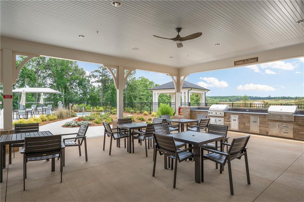 2426 Naples Street Hoschton, GA 30548 - Photo 9 of 11 a view of a dining room with furniture window and outside view