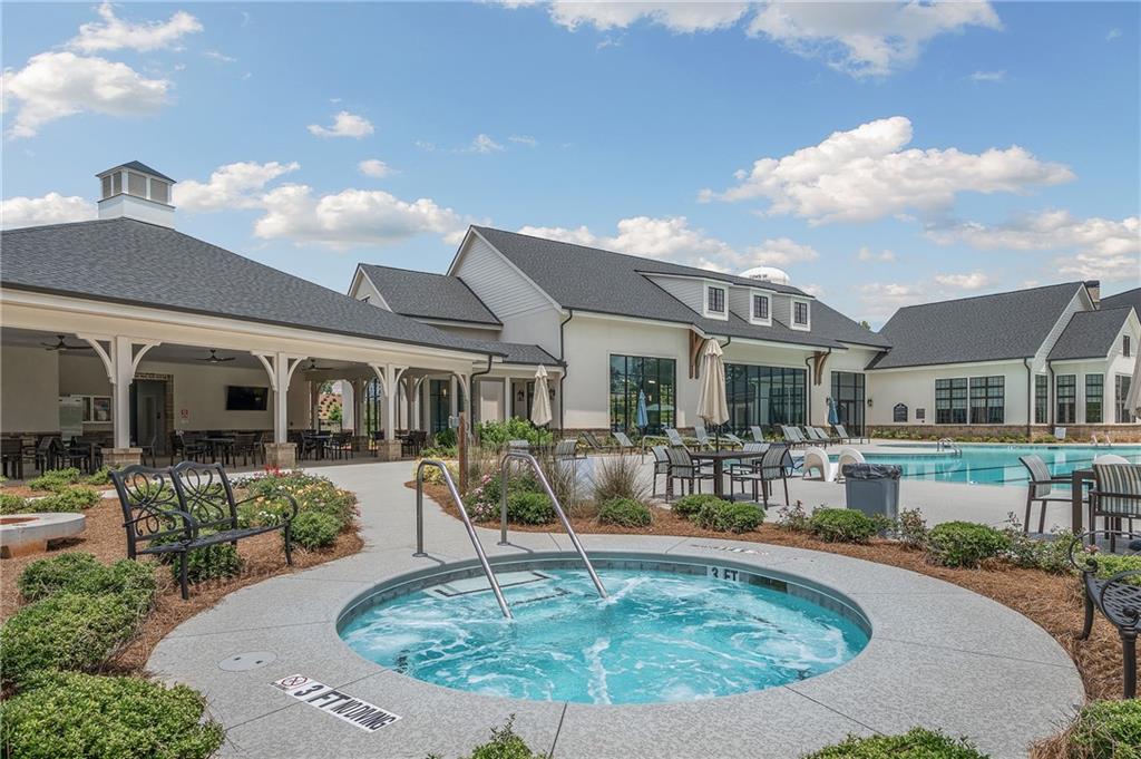 2426 Naples Street Hoschton, GA 30548 - Photo 10 of 11 a view of a house with swimming pool and sitting area
