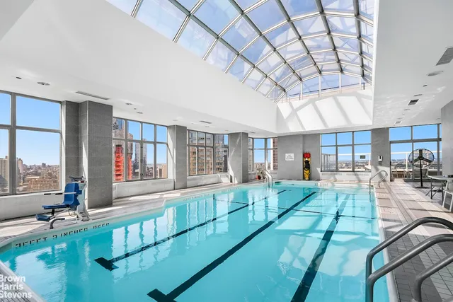 a living room with fireplace furniture and a large window