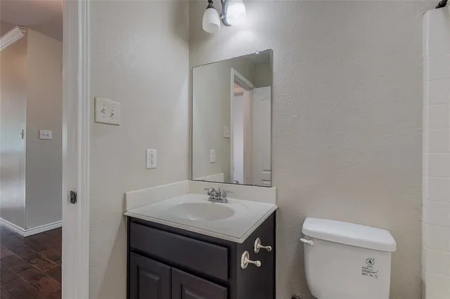 a bathroom with a sink toilet and a mirror