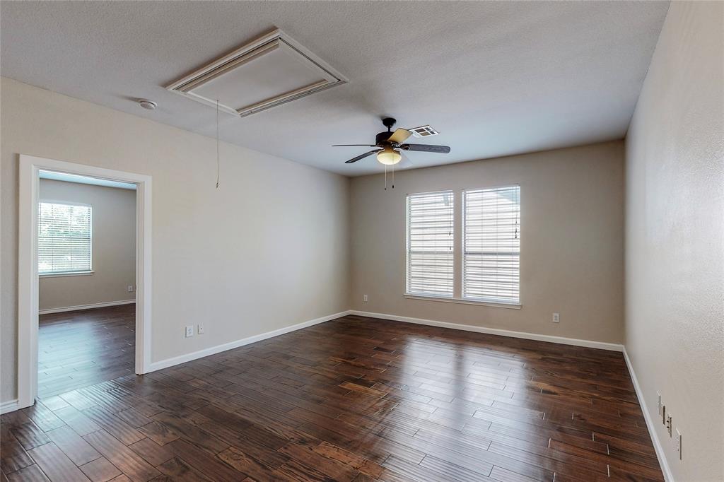 2855 Coteau Way Dallas, TX 75227 - Photo 12 of 35 a view of an empty room with a window and wooden floor