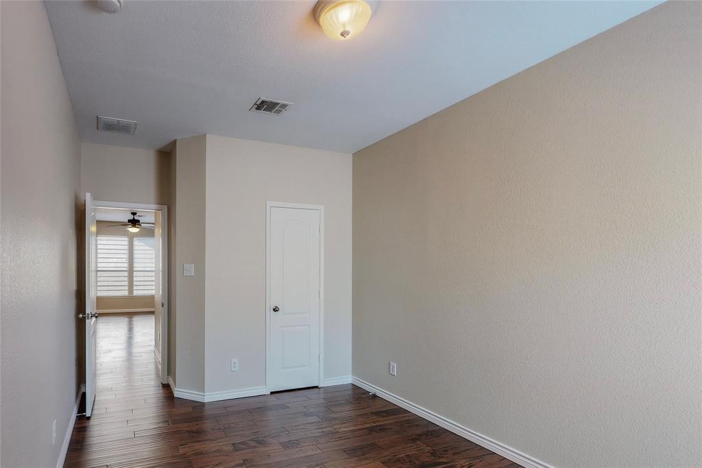 2855 Coteau Way Dallas, TX 75227 - Photo 17 of 35 a view of an empty room with wooden floor and windows