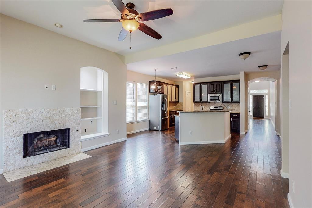 2855 Coteau Way Dallas, TX 75227 - Photo 34 of 35 a view of a kitchen with a sink stove cabinets and a fireplace
