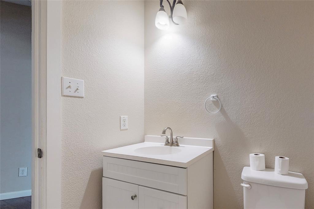 2855 Coteau Way Dallas, TX 75227 - Photo 19 of 35 a bathroom with a sink and a toilet